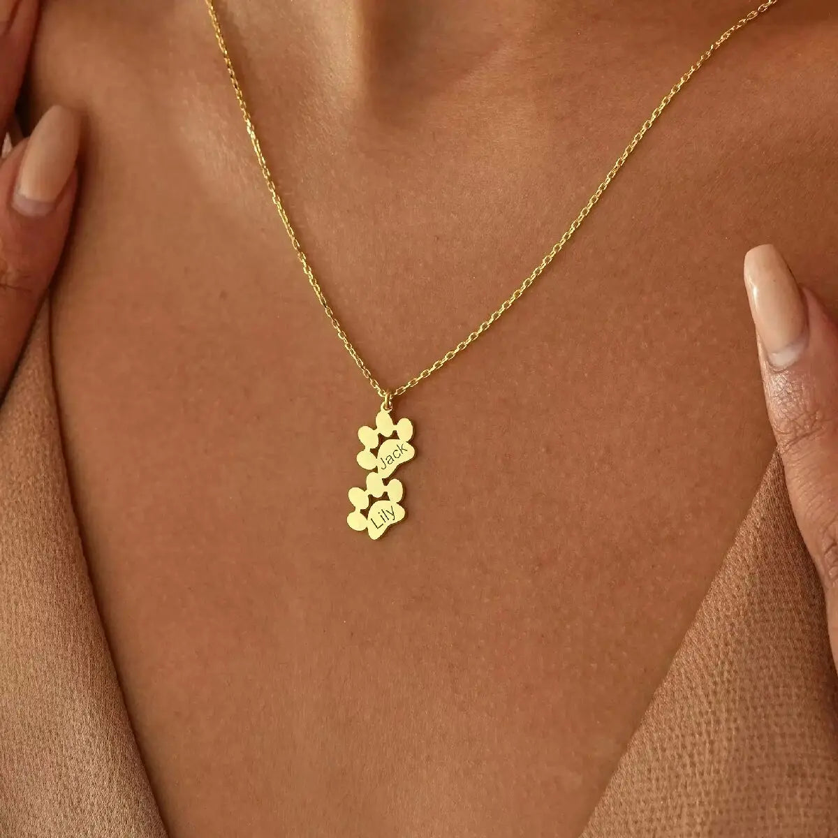 Personalized gold dog paw pendant featuring engraved name Oliver